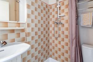 a bathroom with a shower with a toilet and a sink at Côté Jardin in Bédoin +36 photos