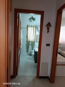 a hallway of a bathroom with a sink and a toilet at Vacanze da Paola in Campomarino