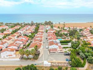 an aerial view of a town with houses and the ocean at Salt & Sun Retreat in Perivolia