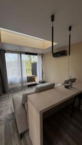 a living room with a couch and a dining table at Aura Glemp & SPA in Laukbeitini