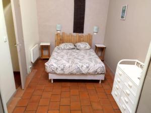 a small bedroom with a bed and two night stands at Gîte au calme l'eclaircie in Régusse +16 photos