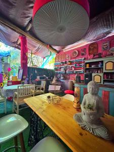 a room with a table with a statue on it at Bell Tent Lovers by Casa das Artes in Luz de Tavira