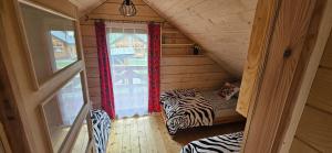 a small room with a bed in a wooden cabin at Chatki U Hanusi in Czchów +46 photos