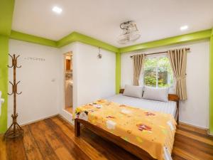 a bedroom with a bed and a window at Villa Koh Rong in Koh Rong Island +30 photos