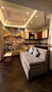 a living room with a couch and a painting on the wall at Porto Matrouh Elabd Family in Marsa Matruh