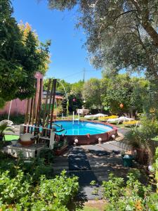 a swimming pool in a yard with a tree at Bell Tent Lovers by Casa das Artes in Luz de Tavira