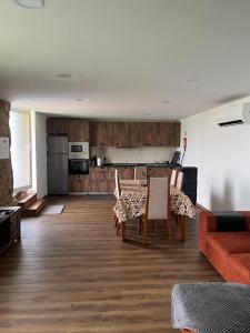 a living room with a couch and a table and chairs at Casa do Canastro in Sever do Vouga