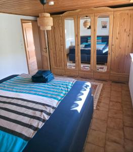 a bedroom with a bed and a wooden cabinet at House of Haiger Ferienwohnung mit Charme in Haiger