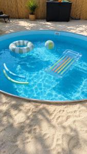 a swimming pool with balls and buoys in it at Lara Beach & Resort in Zepkow