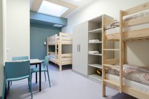 a room with bunk beds and a table and chairs at Märjamaa spordihoone in Märjamaa +23 photos