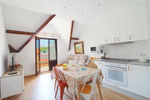 a kitchen with a table with a table cloth on it at Apartamento Arena Dorada in Somo