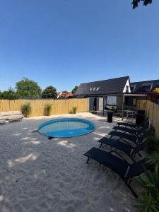 a patio with chairs and a swimming pool at Lara Beach & Resort in Zepkow