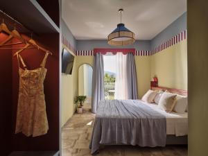 a bedroom with a bed and a window at Memories Apartments - Explore & Recharge in Laganas