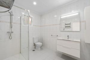 a white bathroom with a toilet and a shower at Paz en Orihuela in Orihuela +13 photos