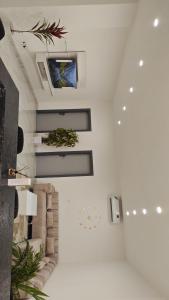 a living room with a tv on a wall at THE TIMES HOUSE, Toit panoramique vue mer & groupe électrogène in Libreville
