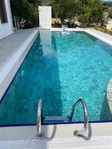 a swimming pool with blue water in a house at Muğladaki Eviniz in Muğla +8 photos
