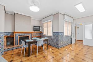 a room with a table and chairs and a fireplace at Paz en Orihuela in Orihuela