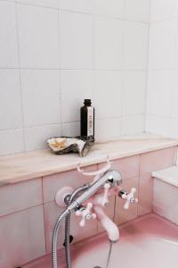 a bathroom with a bath tub with a faucet at Aurega Vintage Bedrooms by Lethes Legacy in Ponte de Lima