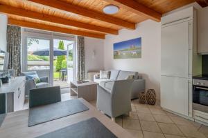a kitchen and living room with a table and chairs at Nordsee-Apartments Hinrichsen in Husum