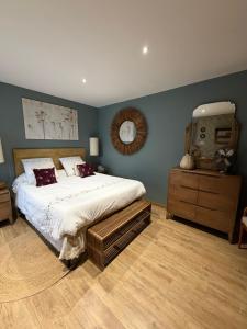 a bedroom with a large bed and a mirror at Céline et Olivier in Pornic