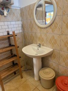 a bathroom with a sink and a mirror at Résidence Maeva in Mtsamboro +7 photos