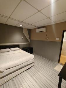 a bedroom with a white bed in a room at Sea Lion Pulau Ketam Inn in Bagan Teochew +5 photos