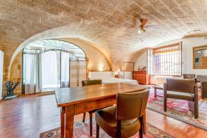 a dining room with a wooden table and chairs at Au Fil Des 5 Saisons in Vers Pont du Gard