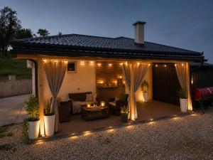 a wooden deck with lights on a house at Vikendica SUNCE in Banja Luka