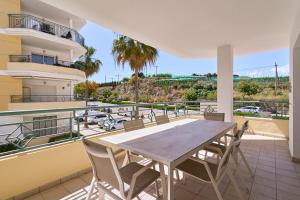 a table and chairs on the balcony of a building at Club Oasis Flat in Málaga