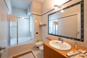 a bathroom with a sink and a shower and a toilet at La Basilica in Verbania +19 photos