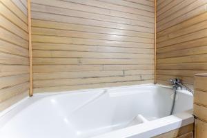a white bath tub in a room with wooden walls at Le Mas Perdu Gîte Studio Parme in Saint-Christol-lès-Alès +17 photos