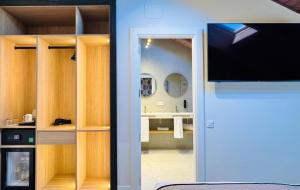 a view of a bathroom from a room with a tv at Soho Boutique La Harinera in Valladolid
