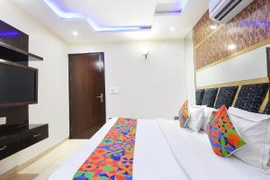 a bedroom with a bed and a television in a room at FabHotel Dev Palace II - Nr Ashok Vihar in New Delhi