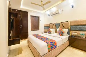 a bedroom with a large bed in a room at FabHotel Dev Palace II - Nr Ashok Vihar in New Delhi