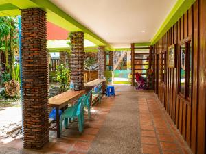 a patio with benches and tables on a building at Villa Koh Rong in Koh Rong Island