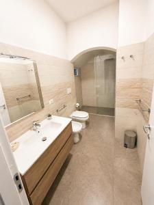 a bathroom with a sink and a toilet at Donna Ginevra Rooms - A soli 300m dalla Spiaggia in Lido Marini +64 photos