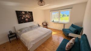 a bedroom with a bed and a couch and a window at Panorama Haus am Traunsee in Traunkirchen +37 photos