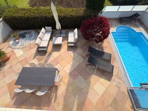 an overhead view of a patio with chairs and a pool at Panorama Haus am Traunsee in Traunkirchen