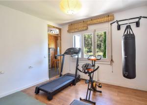 a gym with a punching bag and a treadmill at Begur "Casa es Pou" in Begur