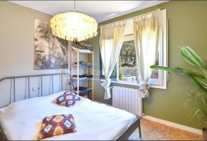 a bedroom with a bed and a chandelier at Begur "Casa es Pou" in Begur