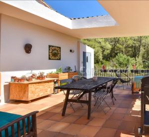 a patio with a table and chairs on it at Begur "Casa es Pou" in Begur