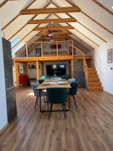 a dining room with a table and chairs and a television at Apartmán Ateliér in Bílé Vchynice