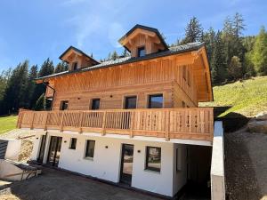 a house with a deck on top of it at NockLodge Sankt Oswald in Bad Kleinkirchheim