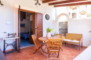 a dining room with a table and chairs at Villa Artemis by Isula in Lipari +34 photos