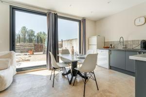 a kitchen and dining room with a table and chairs at Mas Delorme 2 in Arles