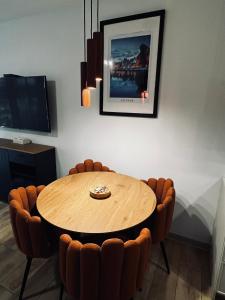 a dining room with a wooden table and chairs at Marina Portovo in Gdańsk