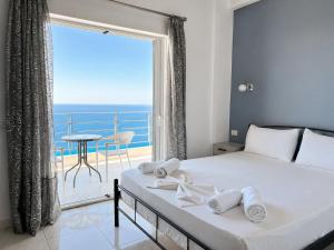 a bedroom with a bed with a view of the ocean at Palasa View in Dhërmi
