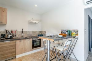 a kitchen with a counter with stools in it at Mas Delorme 1 in Arles