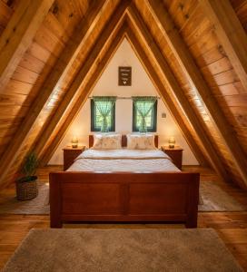 a bedroom with a bed in a attic at White pine cottage in Motički Gaj