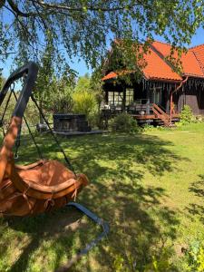 a swing in a yard in front of a house at Gajówka in Istebna